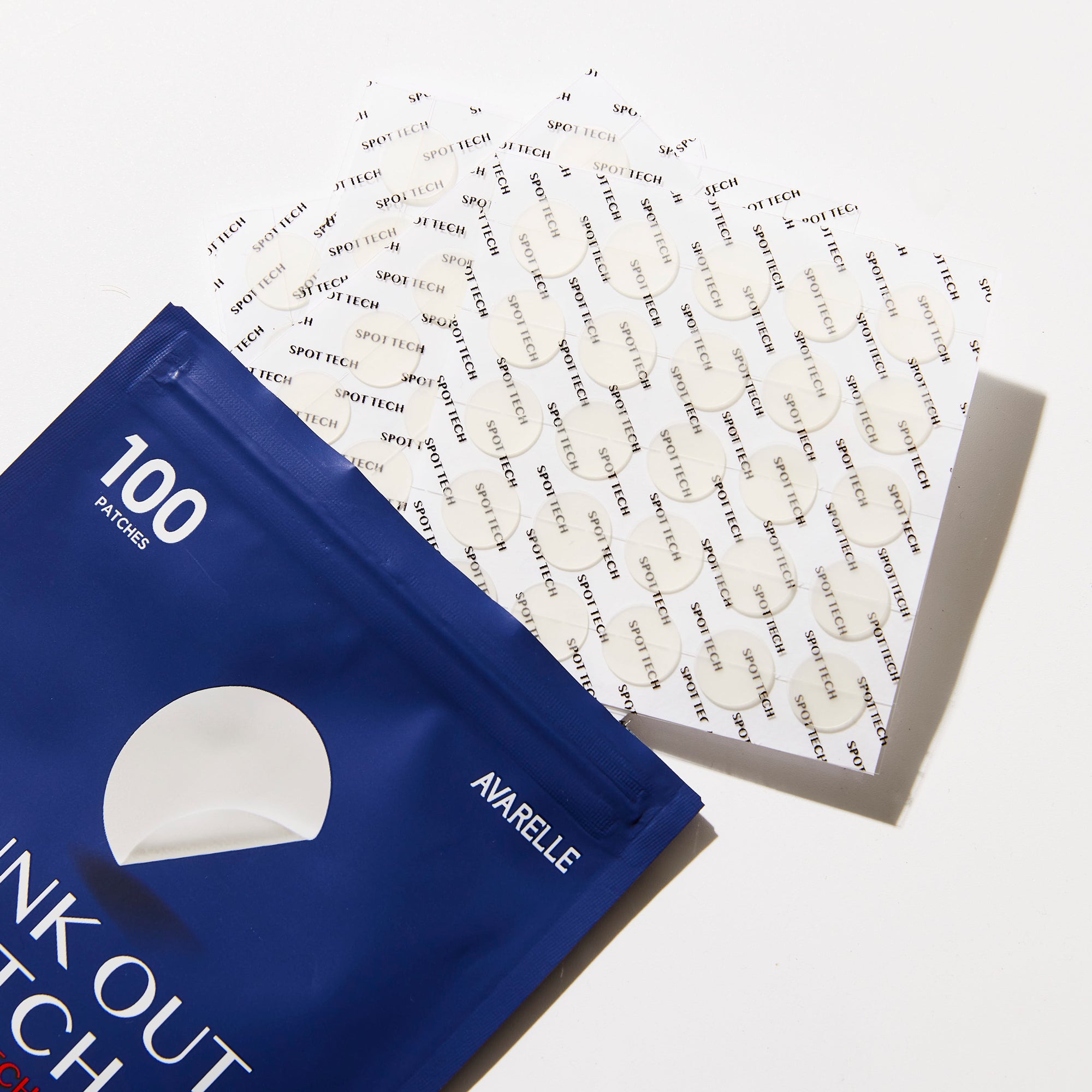 A packet of Avarelle GUNK OUT: Spot Tech 100CT acne patch covers displayed with some patches out of the package, featuring hydrocolloid technology and tea tree oil.